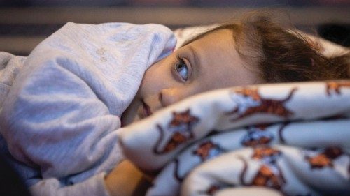 A child rests in a ferry turned into a makeshift healthcare facility for victims of the deadly ...