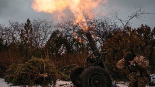 TOPSHOT - A Ukrainian serviceman of the 93rd brigade covers his ears while firing a French 120mm ...