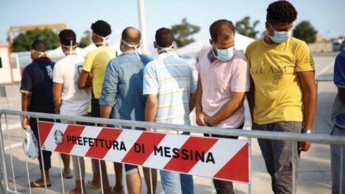 FILE PHOTO: Migrants queue after disembarking from Open Arms rescue boat after arriving at Messina ...