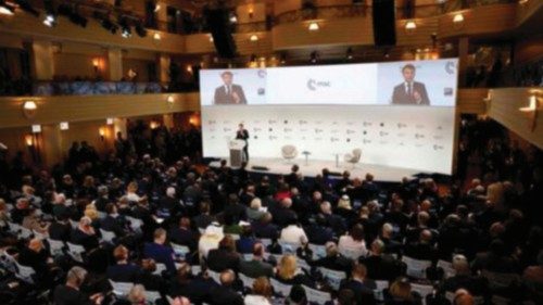 French President Emmanuel Macron is displayed on screens as he addresses participants of the Munich ...