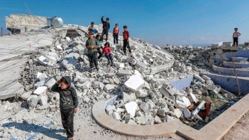 Children stand on the rubble of a collapsed building in the aftermath of the February 6 deadly ...