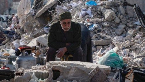 TOPSHOT - An elderly man sits among the rubble of collapsed buildings in Kahramanmaras, southeastern ...