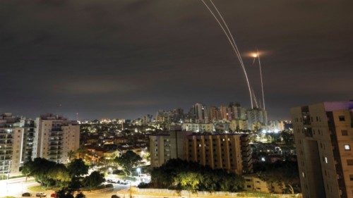 A trail of smoke is seen as rockets from Gaza are intercepted in the early morning, as seen from ...