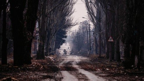 Local residents walk down a street as the sounds of shelling continue  in Bakhmut on February 27, ...
