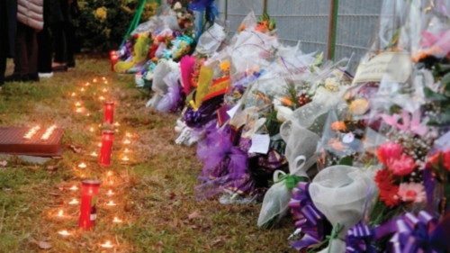 Candles and flowers are seen outside the Crotone Palasport, the funeral home for the  migrants who ...