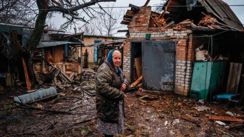 TOPSHOT - An elderly woman stands in her backyard after shelling in Chasiv Yar, near Bakhmut on ...