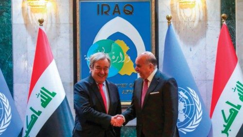 Iraq's Foreign Minister Fuad Hussein (R) shakes hands with UN Secretary-General Antonio Guterres at ...