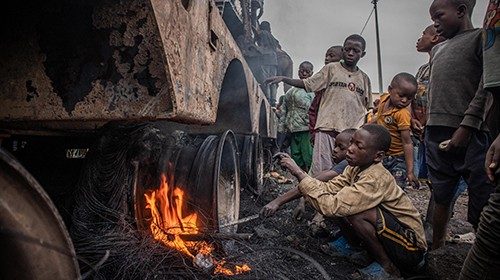 Children dismantle a vehicle belonging to the United Nations Organization Stabilization Mission in ...