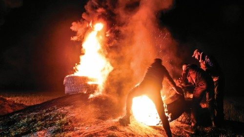 TOPSHOT - Palestinian youths burn tires during a protest near the Israel-Gaza border, East of Gaza ...