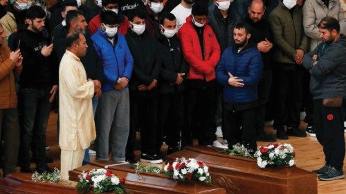 Mourners, including survivors, pray near coffins of victims who died in a migrant shipwreck, in ...