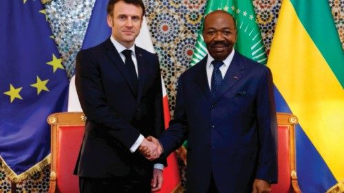 TOPSHOT - French President Emmanuel Macron (L) shakes hands with Gabon's President Ali Bongo Ondimba ...