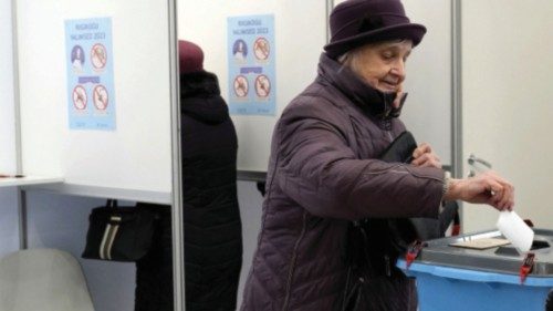 A woman casts her vote during a general election advance voting in Tallinn, Estonia March 1, 2023. ...