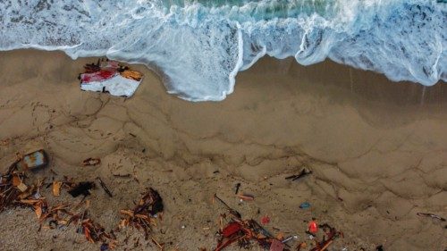 An aerial photograph taken on February 28, 2023 shows pieces of wood washed up on the beach, two ...
