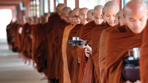 epa10502284 Buddhist novices line up for lunch alms at a monastery on the eve of the Full Moon Day ...