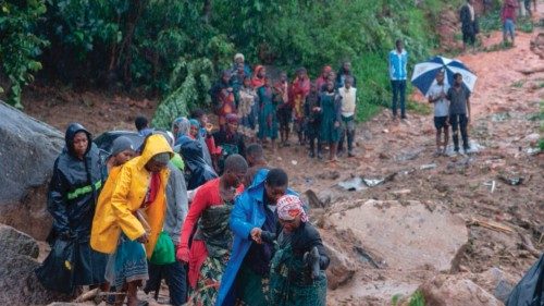People walk up a hill in Blantyre on March 14, 2023, following cyclone Freddy's landfall. - Cyclone ...