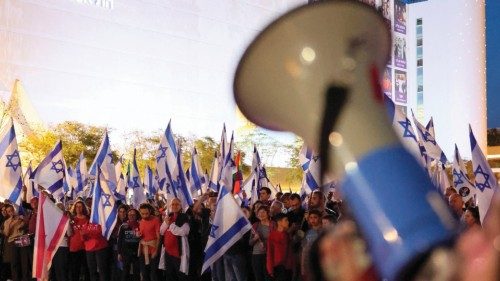 People chant slogans and wave national flags during a protest against the Israeli government's ...