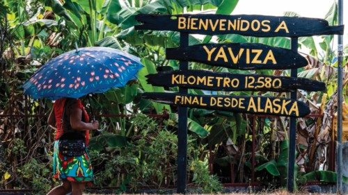 A woman walks by a welcome sign at Yaviza town, Darien Province in Panama, on March 9, 2023. - ...
