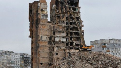 An xcavator demolishes a multi-storey apartment block, which was destroyed in the course of ...