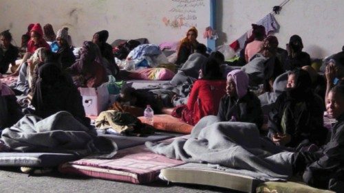 A picture shows migrant children sitting at the Abu Salim Center for illegal immigration, women and ...