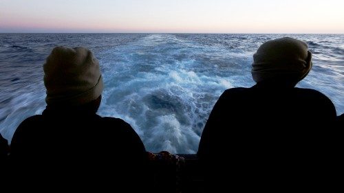 Rescued migrants look out to sea on the Geo Barents rescue ship, operated by Medecins Sans ...