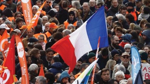 Protesters hold the French national flag and French labour union flags during a demonstration as ...