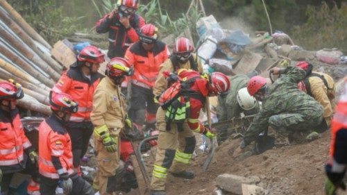 epa10546303 Rescuers search for people buried after a landslide in Alausi, Ecuador, 27 March 2023. ...