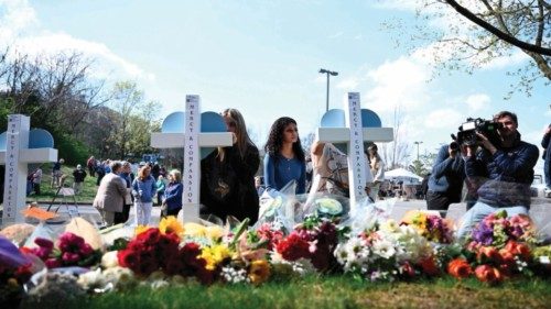 TOPSHOT - People pay their respects at a makeshift memorial for victims at the Covenant School ...