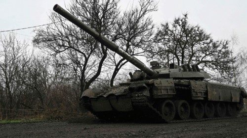 A Ukrainian tank rolls on a muddy road near Bakhmut, Donetsk region, on March 29, 2023, amid the ...