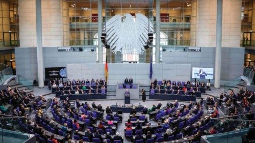 A general view shows Britain's King Charles III (C) delivering a speech in front of members of ... A general view shows Britain's King Charles III (C) delivering a speech in front of members of ...