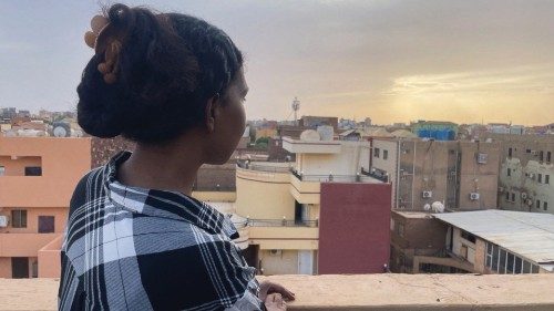 Hamsa looks out at the city from the roof-top of her house during the conflict in Khartoum, Sudan, ...