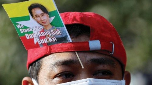 FILE PHOTO: A Myanmar protester residing in Japan uses a flag with an image of deposed Myanmar ...
