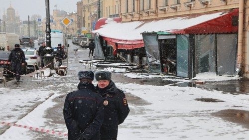 Police officers stand guard at the scene of the cafe explosion in which Russian military blogger ...