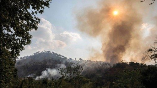 Smoke billows out from a forest fire on a mountain-side in Nakhon Nayok province, northeast of ...
