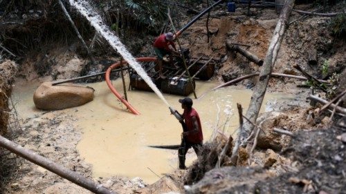 FILE PHOTO: Miners work in an illegal gold mine at an environmental preservation area in the Amazon ...