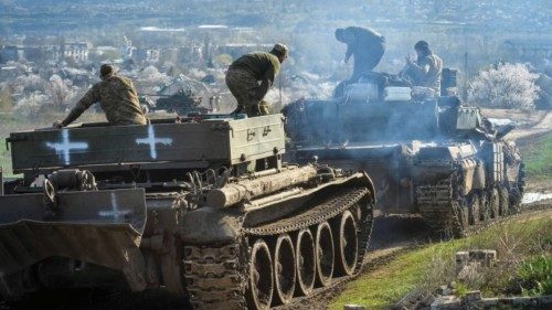 Ukrainian service members ride tanks, as Russia's attack on Ukraine continues, near the front line ...