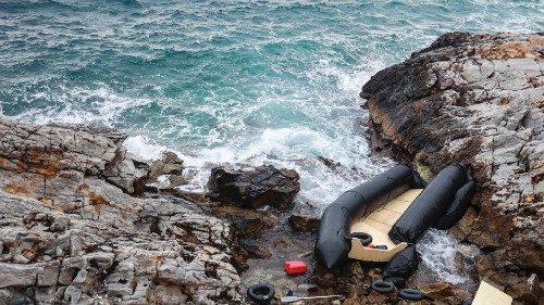A rubber boat, believed to be used by migrants, lies destroyed on the rocky shoreline, in Thermi on ...