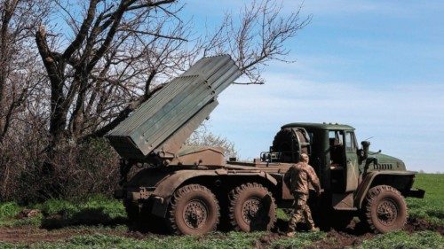 Ukrainian artillerymen prepare a BM-21 Grad multiple rocket launcher to fire towards Russian ...