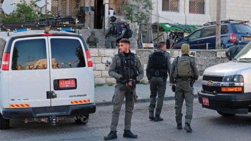 Israeli security forces search for suspects following a shooting attack in the neighbourhood of ...
