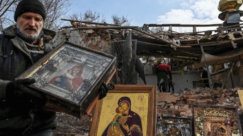 Man carries an Orthodox icon at a site of a church destroyed by a Russian missile strike, amid ...
