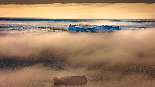 TOPSHOT - Icebergs are seen through the fog floating in Baffin Bay near Pituffik, Greenland on July ...