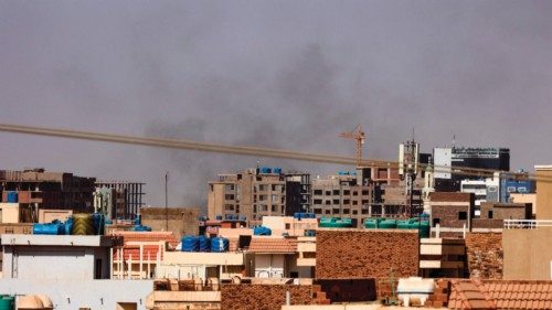 Smoke billows over residential buildings in eastern Khartoum on April 22, 2023, during ongoing ...