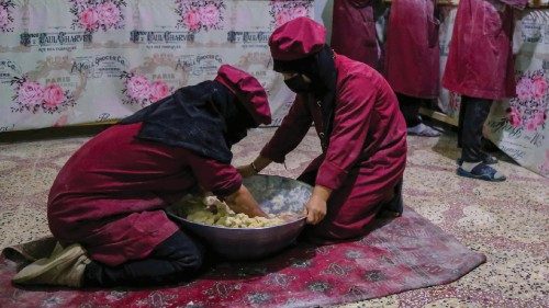 epa10580765 Afghan women prepare snacks at a factory in Kabul, Afghanistan, 19 April 2023. A factory ...