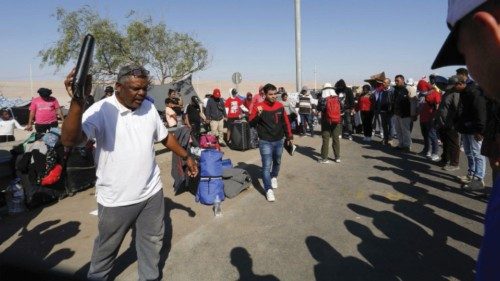 Undocumented migrants mostly from Venezuela, Colombia and Haiti pray as they remain stuck in Chile, ...