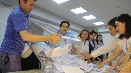 Members of a local electoral commission count ballots at a polling station in Tashkent, on April 30, ...