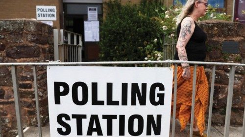 FILE PHOTO: A woman leaves a polling station as voting gets under way in the Tiverton and Honiton ...
