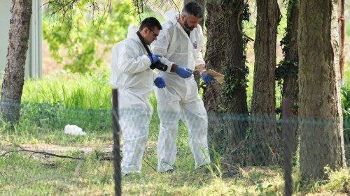 Members of the forensic team inspect the crime scene, in the aftermath of a shooting in Malo Orasje, ...