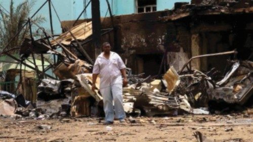 FILE PHOTO: A man walks near damaged buildings at the central market during clashes between the ...