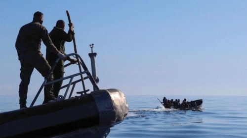 Tunisian coast guards try to stop migrants at sea during their attempt to cross to Italy, off Sfax, ...