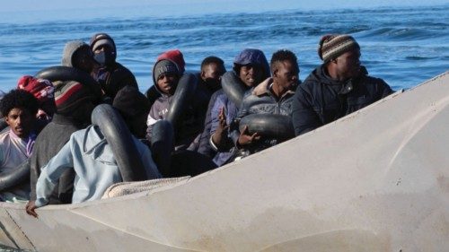 Migrants are pictured on a metal boat as Tunisian coast guards try to stop them at sea during their ...