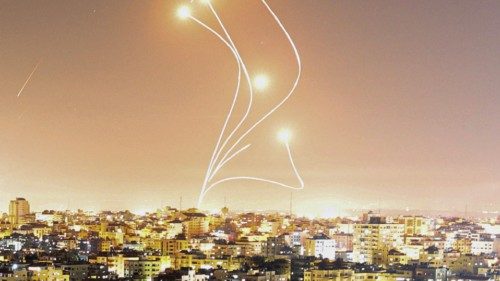 TOPSHOT - Israel's Iron Dome air defence system intercepts rockets launched from Gaza City, on May ...